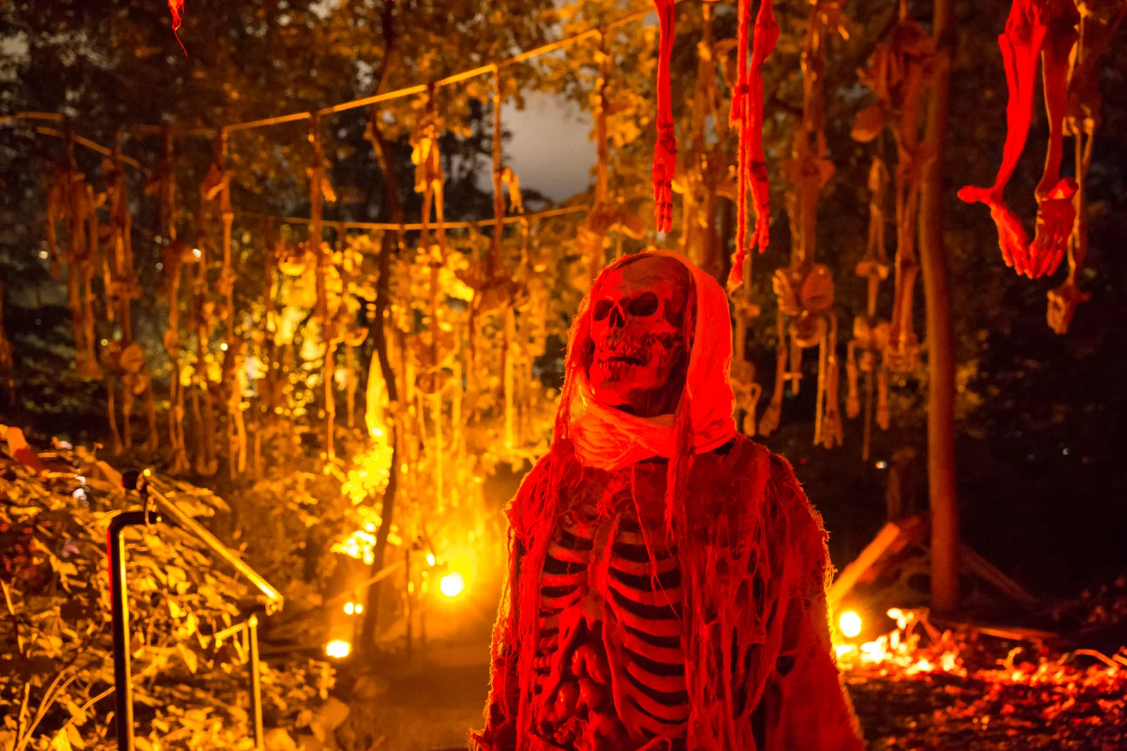 Red-lit skeleton figure along an outdoor Halloween trail in a supplied Legends of Horror archive image