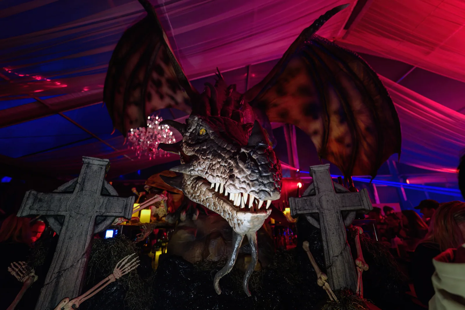 Large winged creature prop in a pink-lit room at a past Legends of Horror production
